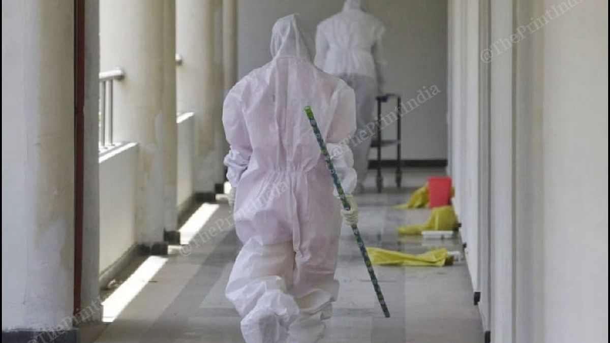 Workers in hazmat suits leave after bringing us lunch at our Covid-19 quarantine centre | Photo: Praveen Jain | ThePrint