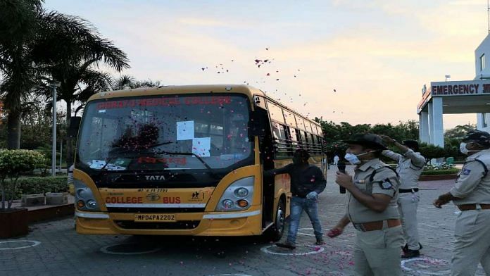 Rose petals are showered as the 44 patients discharged Wednesday evening set off from Bhopal’s Chirayu Medical College and Hospital Wednesday evening | Angana Chakrabarti | ThePrint