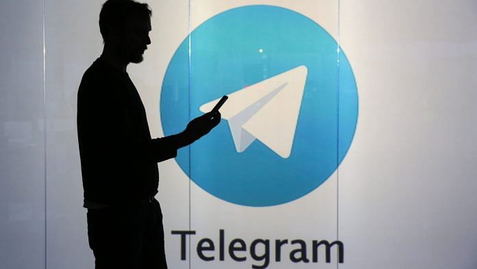 Representational Image | A man standing against an illuminated wall bearing Telegram's logo in London | Photo: Chris Ratcliffe | Bloomberg