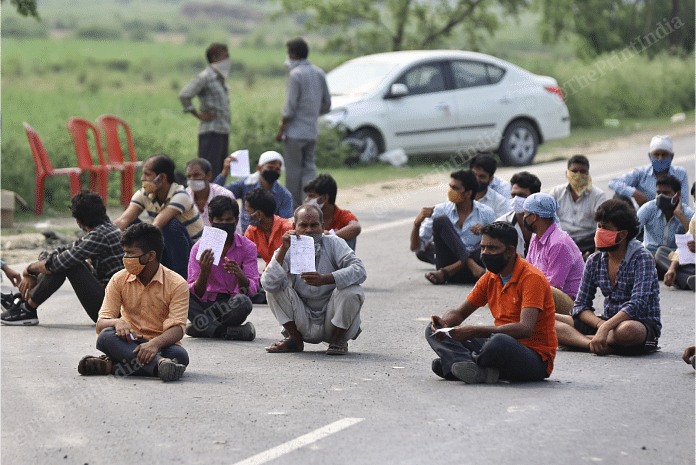 Migrants workers and laboures who were travelling to their respective places are sitting on the road and waiting for their turn to be screened at Uttar Pradesh - Patna border | Photo: Suraj Singh Bisht | ThePrint