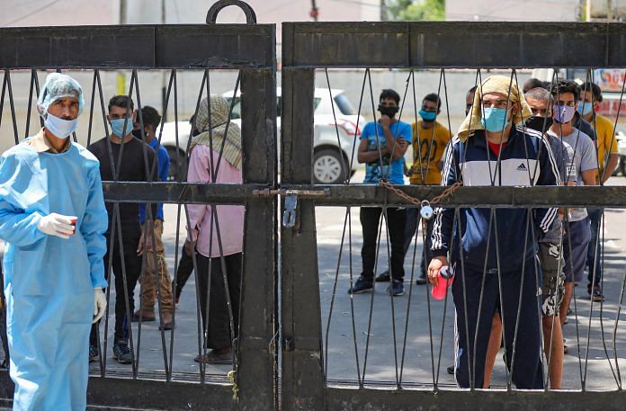 Representational image. People wearing face masks wait outside Government Hospital Gandhi Nagar for their COVID-19 test, during the ongoing nationwide lockdown, in Jammu, Friday, May 22, 2020. (PTI Photo)