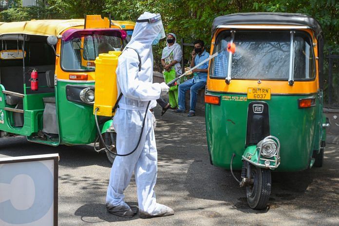 (Representational image) A health worker wearing a PPE kit sanitizes auto-rickshaws, during the ongoing Covid-19 lockdown, in New Delhi | Photo: PTI