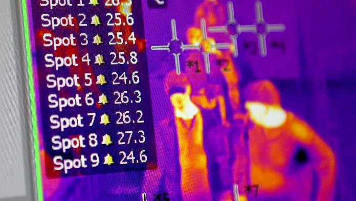 A thermal scan image of arriving passengers is displayed on a screen at border control to help monitor possible coronavirus cases, at Belgrade Nikola Tesla Airport in Belgrade, Serbia. | Bloomberg