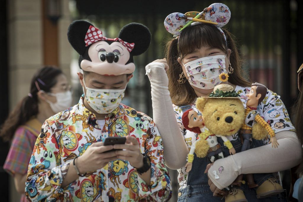 Visitors wearing Disney-themed protective masks during the reopening of the Walt Disney Co. Shanghai Disneyland theme park | Bloomberg