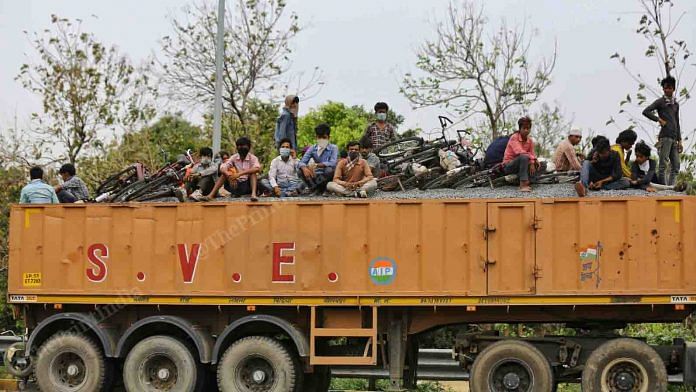 A truck offers migrant workers a lift on the highway | Suraj Singh Bisht | ThePrint