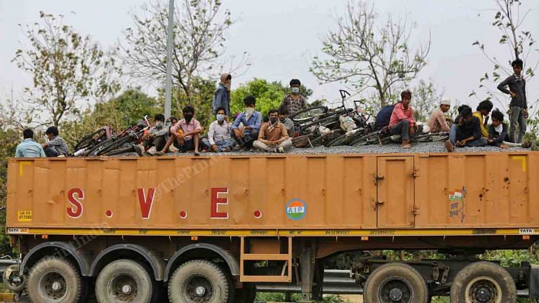 Hitching rides on trucks, highway pit stops in the heat — migrants continue their walk home
