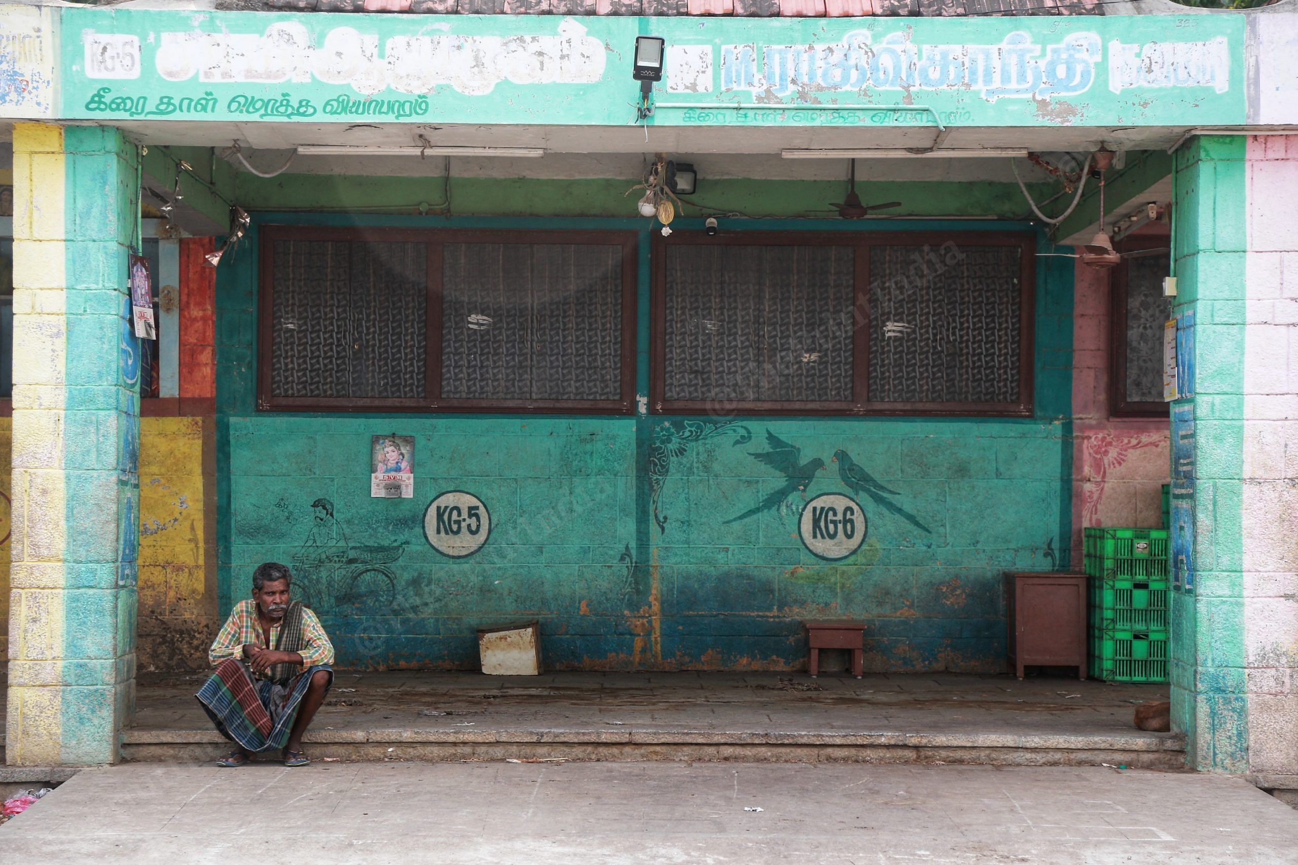 A worker sits in front of a shuttered shop in Koyambedu market | Manisha Mondal | ThePrint