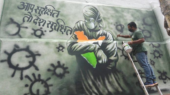 An artist draws a mural on a wall to spread awareness, during the ongoing Covid-19 lockdown in Guwahati on 6 May 2020 | PTI