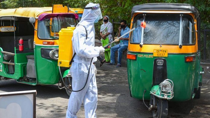 A health worker sanitises auto-rickshaws during Covid-19 lockdown in New Delhi | PTI File photo
