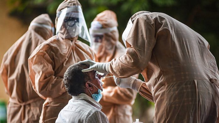 Medics collect a swab sample for COVID-19 (Representational image) | PTI