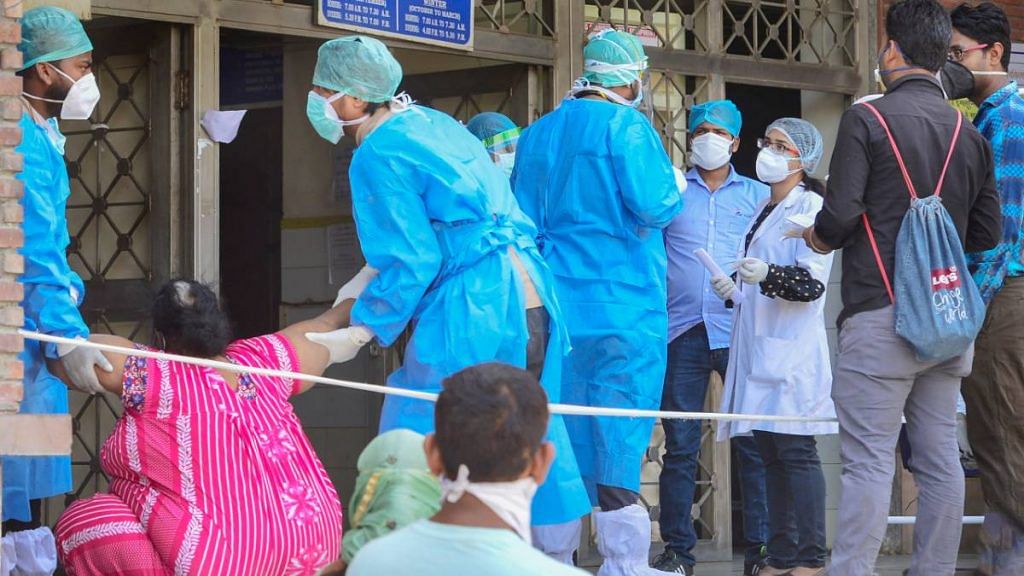 (Representational image) Medics attend to a suspected Covid-19 patient at a government hospital during the ongoing nationwide lockdown to curb the spread of coronavirus, in New Delhi | Kamal Kishore | PTI