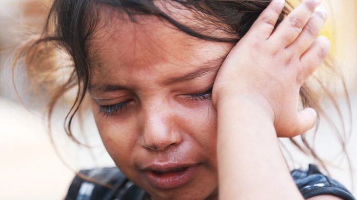 A girl cries as she couldn't spot her parents at the crowded screening centre in New Delhi's Chhatarpur. She found them later. | Photo: Manisha Mondal | ThePrint