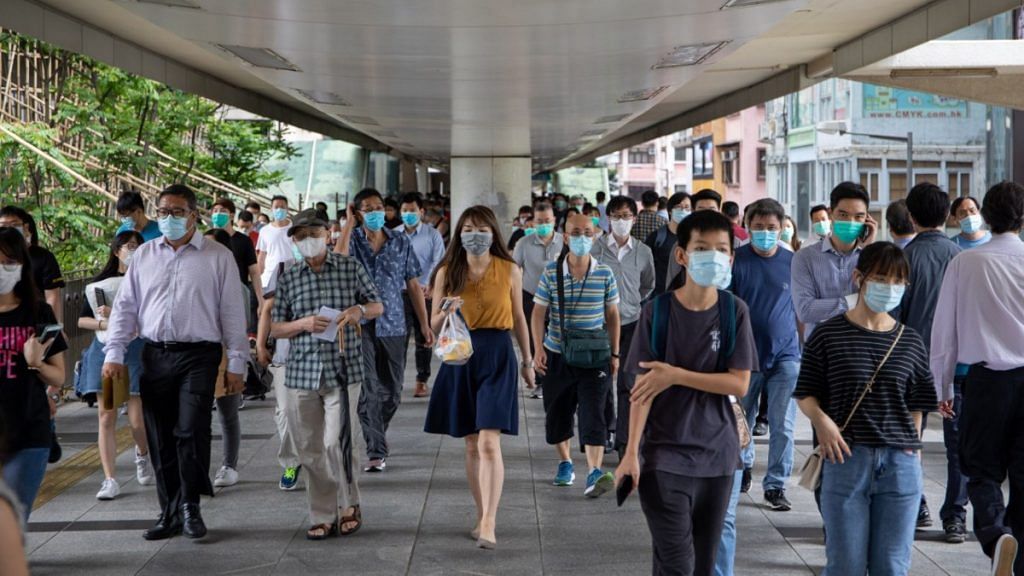 Pedestrians wear protective masks in the Wan Chai district of Hong Kong. The study was conducted across six hospitals in the city | Paul Yeung | Bloomberg