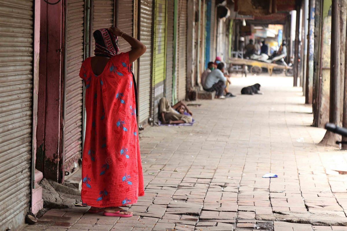 A woman stands outide her home in the empty alley | Photo: Manisha Mondal | ThePrint