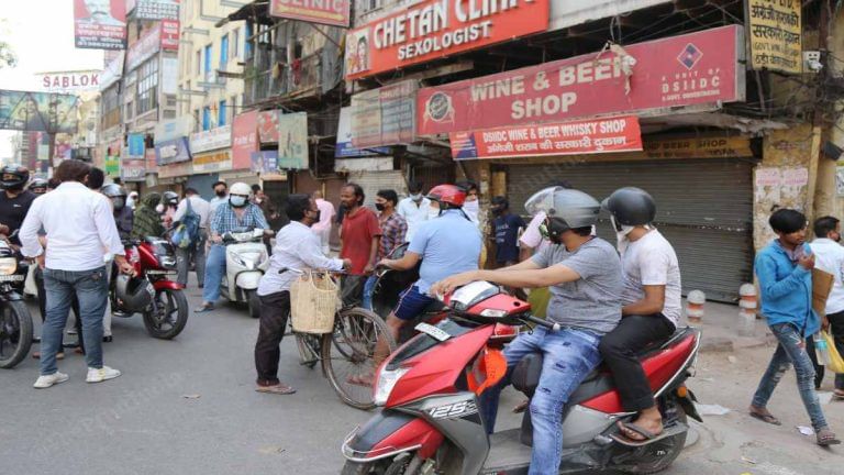 As throng of tipplers shuts down Delhi liquor shops, some wait on, others keep stopping by