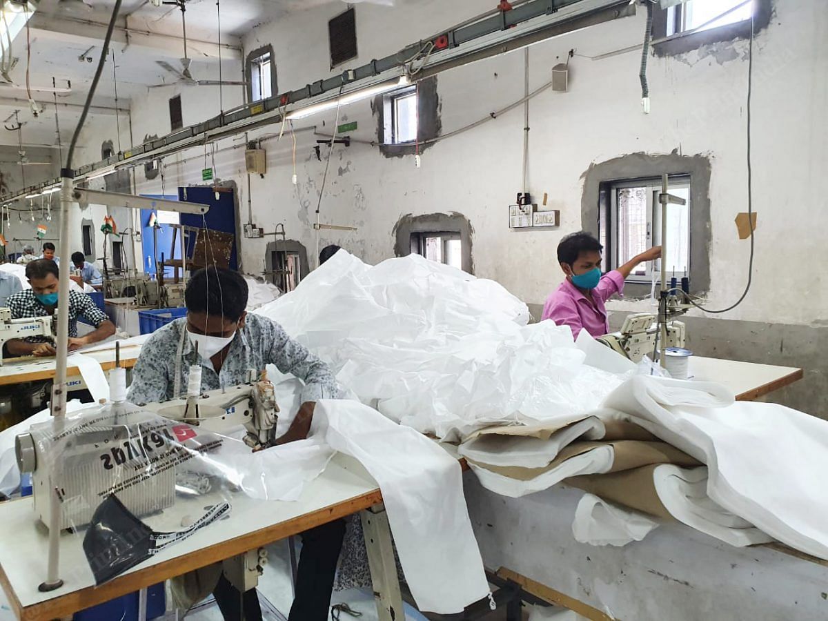 Once the stitching is done, the overall is sent to another team for inspection. Here the team looks for any loose threads or knots that they can trim out. Any spots on the cloth are also sanitised and cleaned | Photo: Soniya Agarwal | ThePrint