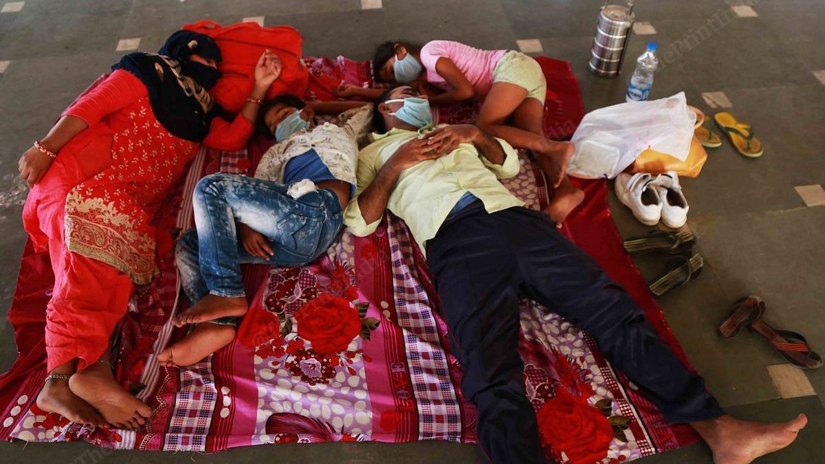 After staying waiting for 24 hours for train finally the workers could sleep on a carpet inside the temple | Photo Manisha Mondal | ThePrint