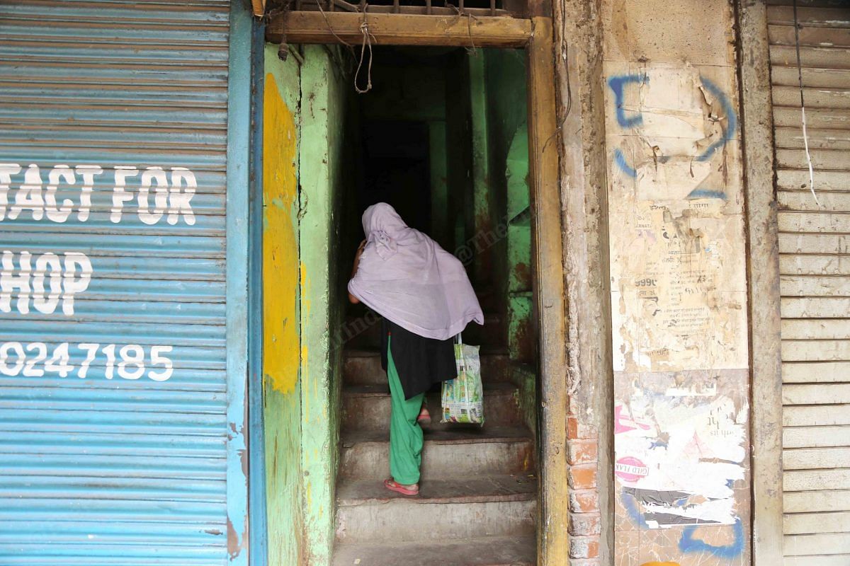 A woman carries ration to the third floor | Photo: Manisha Mondal | ThePrint