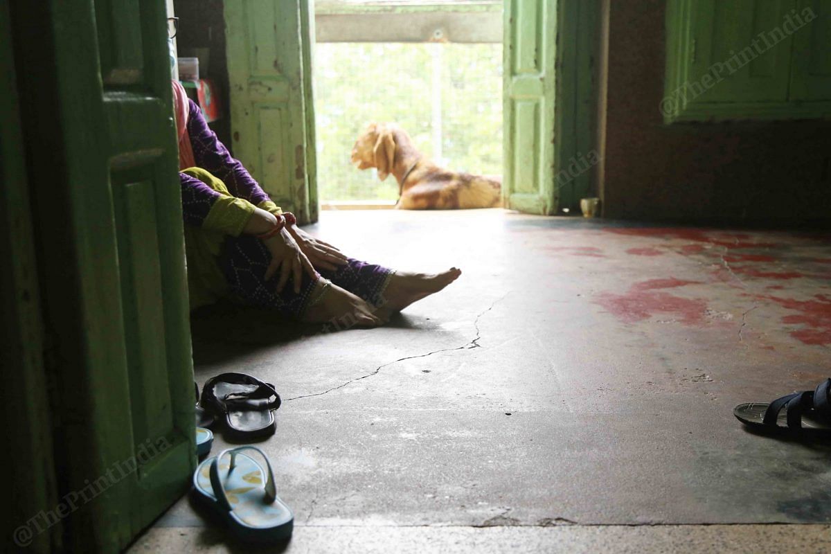 After bringing ration to the third floor, a woman rests | Photo: Manisha Mondal | ThePrint