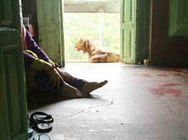 After bringing ration to the third floor, a woman rests | Photo: Manisha Mondal | ThePrint