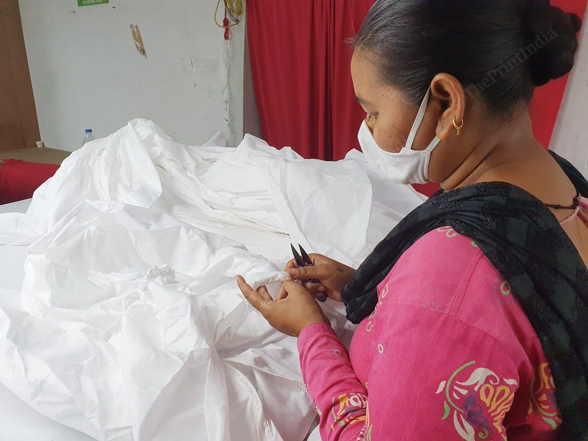 Yogita Patel, a 35 year old from the nearby district of Mehsana, spends 8 hours threading. She says she has a family of four amd working at the factory has helped feeding her family during Covid times | Photo: Soniya Agarwal | ThePrint