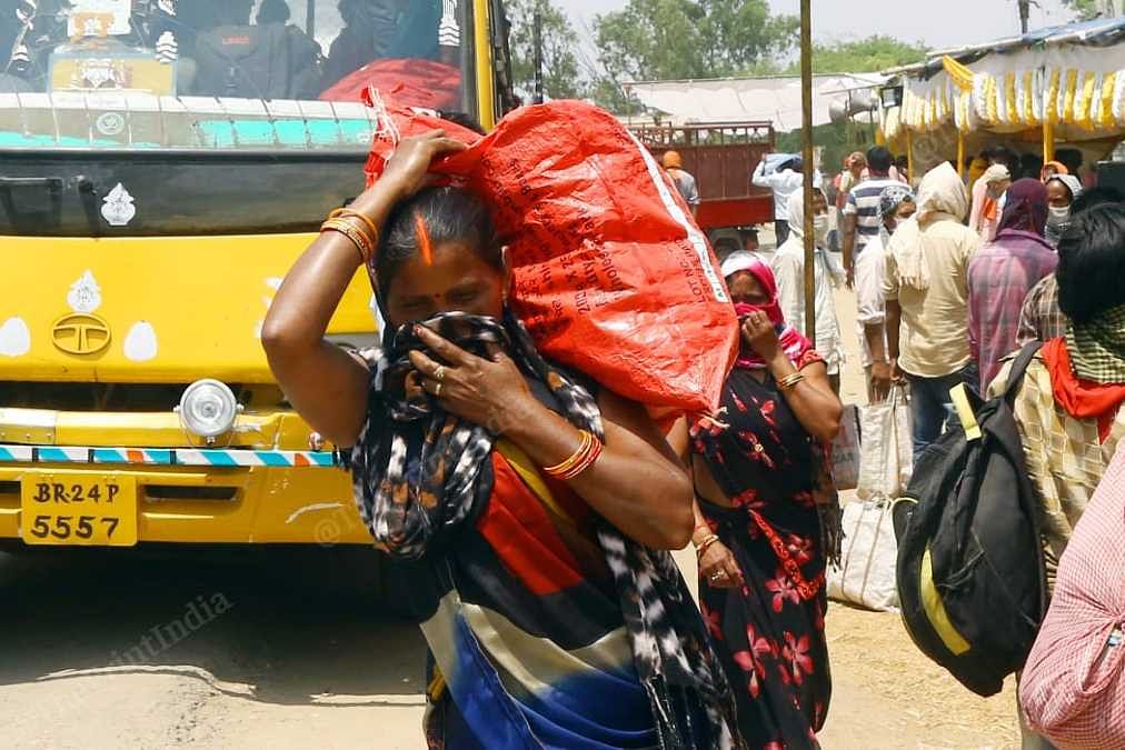 Migrants board buses at the UP-Bihar border | Suraj Singh Bisht | ThePrint