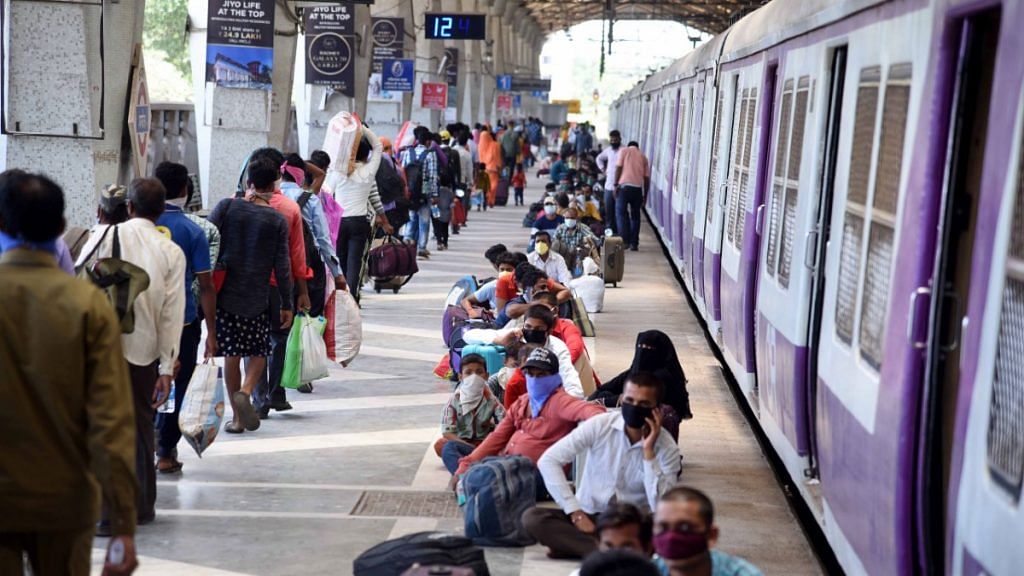 Migrants from Lucknow wait to board Shramik Special train to reach their native places at Panvel Railway Station, during the ongoing Covid-19 lockdown, in Navi Mumbai, on 20 May | PTI