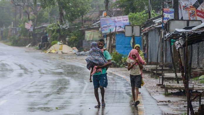 Villagers walk on a road during a storm due to Cyclone Amphan at Kakdwip near Sunderbans area in South 24 Parganas district of West Bengal, Wednesday, May 20, 2020. (PTI Photo)