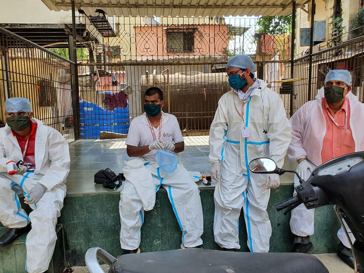 Doctors from One Rupee Clinic taking a breather during screening. They complete screening of 10 buildings in a day but staying in the PPE suit is very challenging | Photo: Soniya Agrawal | ThePrint