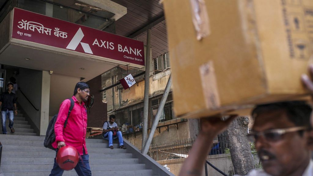 Pedestrians walk past an Axis Bank Ltd. branch in Mumbai, India. | Photographer: Dhiraj Singh | Bloomberg