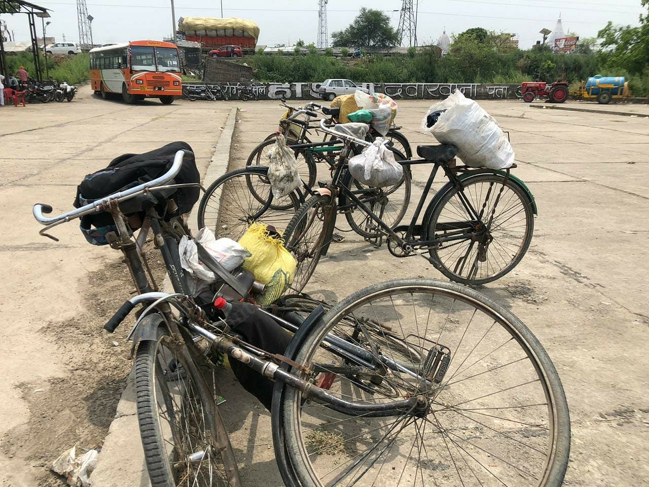 A bus dipot near Amroha on National Highway 24, Delhi-Lucknow Highway, where thousands of tired migrants waited for their number to be announced so that they could finally board the buses to their native destinations. The laborers were in a dilemma whether to abandon their bicycles or not | Photo: Jyoti Yadav | ThePrint
