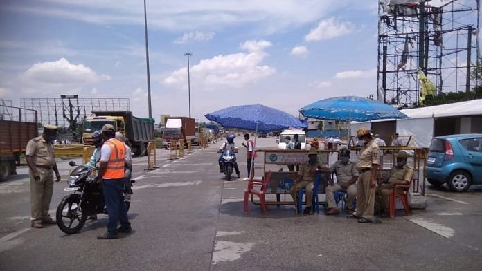 Police officers manning the border at Attibele, the first entry point into Bengaluru from Tamil Nadu. | Photo: By special arrangement