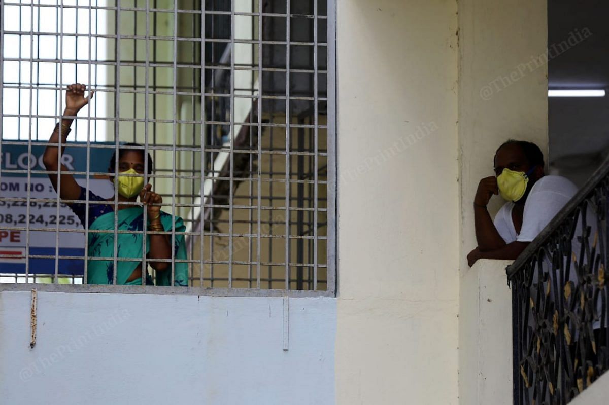 Covid patients passing their time by standing in front of their balconies and window| Photo: Suraj Singh Bisht | ThePrint