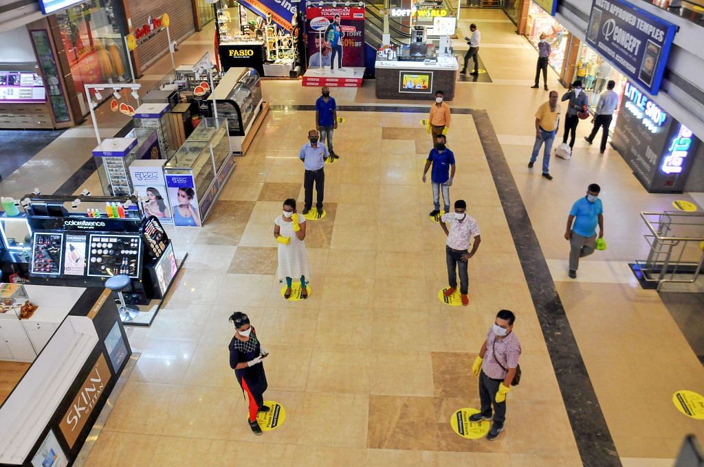 Representational image. Shoppers maintain social distance while standing in a queue at Lake Mall, Kolkata after it reopened Monday. | PTI