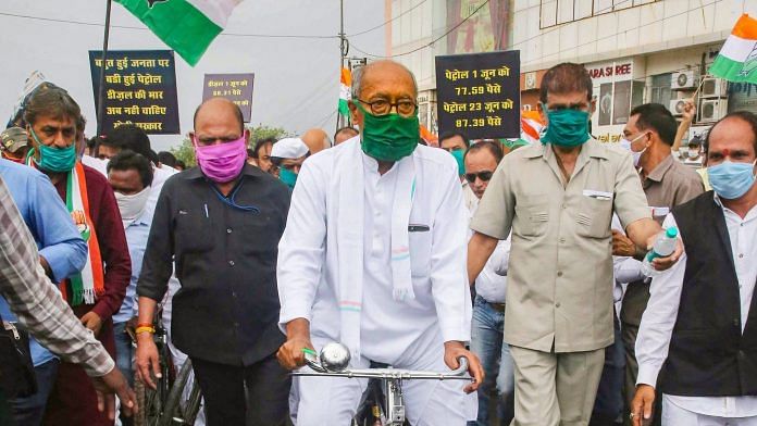 Senior Congress leader Digvijay Singh rides a cycle during a protest against hike in fuel price, in Bhopal | PTI