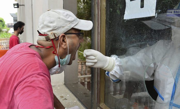 Representational image | A medic collects swab sample for Covid-19 testing at a medical camp in New Delhi 29 June, 2020. | PTI