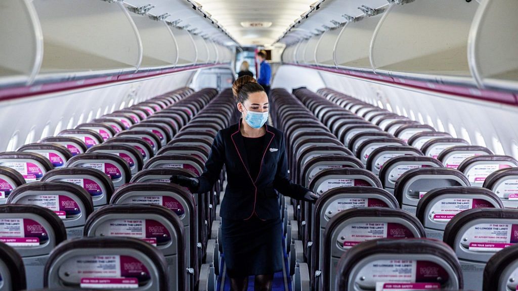 A member of the cabin crew wearing a protective face mask checks cabin seating ahead of the flight on-board a passenger aircraft operated by Wizz Air Holdings Plc at Liszt Ferenc airport in Budapest, Hungary. | Photographer: Akos Stiller | Bloomberg