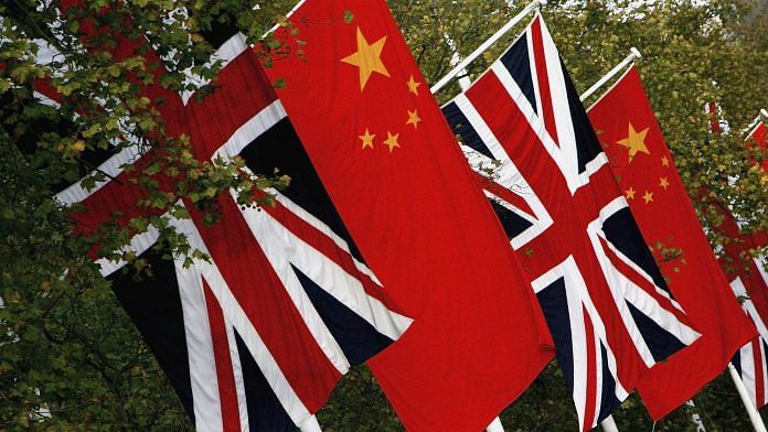 Chinese and British flags fly on Pall Mall on November 7, 2005 in London, England. | Bloomberg