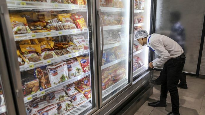 An employee arranges frozen chicken products in a freezer at a Big Bazaar hypermarket, operated by Future Retail Ltd. | Photographer: Dhiraj Singh | Bloomberg