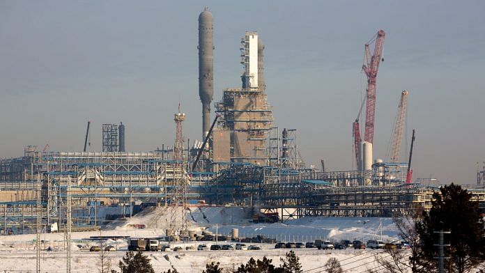 A methane extraction column towers above the site of the Gazprom PJSC Amur gas processing plant in Siberia | Bloomberg