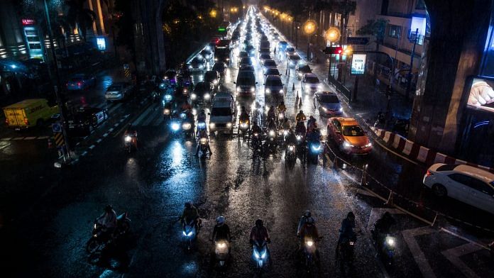 Vehicles sit in traffic in the rain on a road outside the CentralWorld shopping mall in Bangkok, Thailand | Photographer: Taylor Weidman/Bloomberg