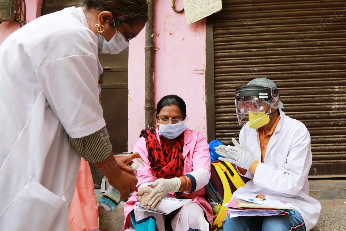 There are strict hygiene guidelines and rules in place for the health workers conducting the serological tests. They are required to sanitise their hands after every test, for example | Manisha Mondal | ThePrint