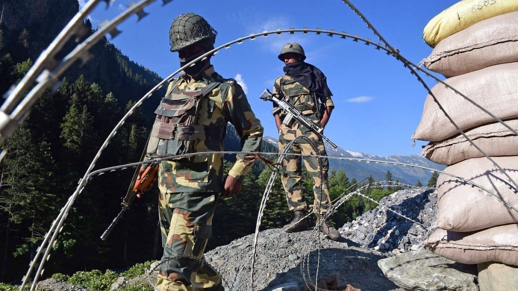 Border Security Force soldiers stand guard at a checkpoint along a highway leading to Ladakh, at Gagangeer in Kashmir's Ganderbal district on 17 June 2020