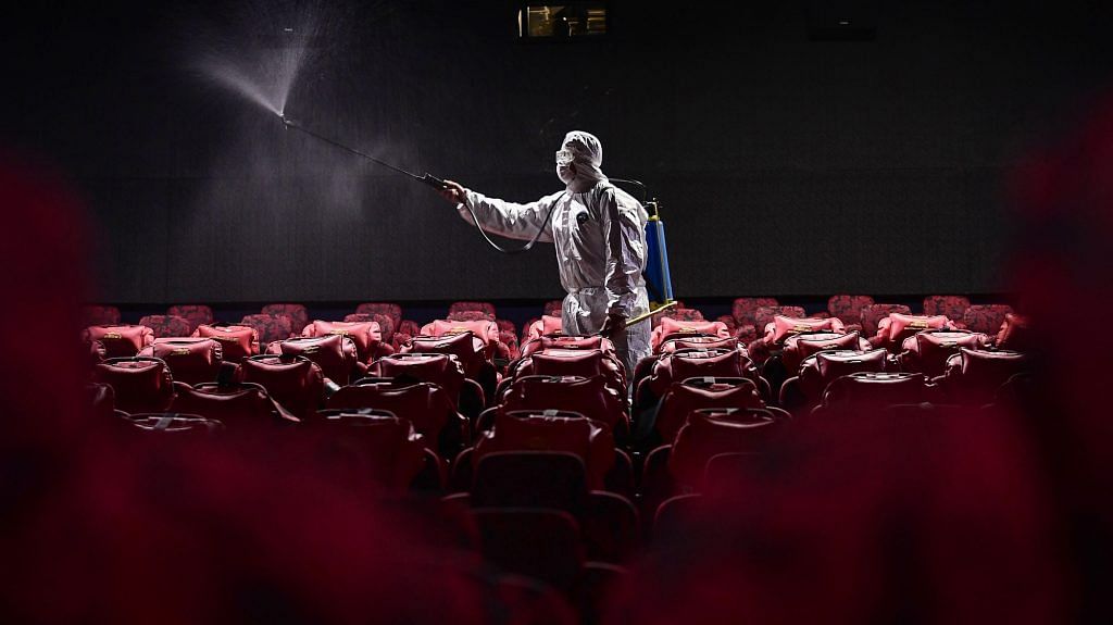 A staff member spraying disinfectant at a cinema in Shenyang in China's northeastern Liaoning province