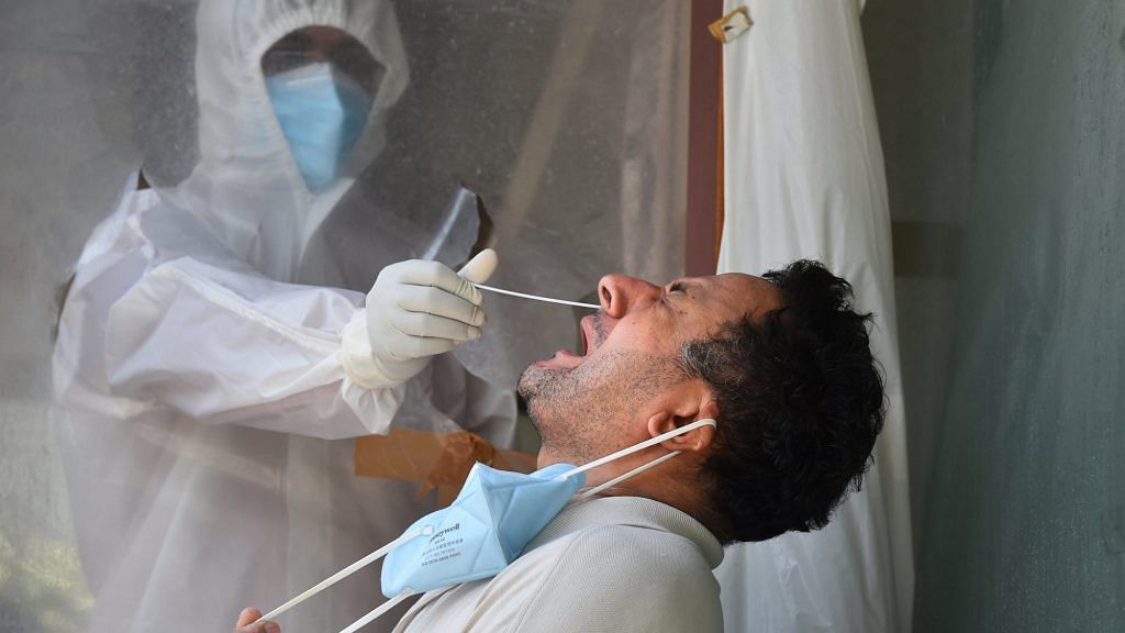 A health worker collects swab sample for the Covid-19 test in New Delhi | PTI Photo