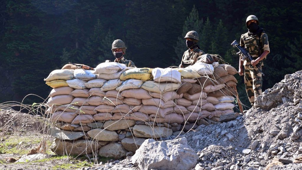 BSF soldiers stand guard at a checkpoint along a highway leading to Ladakh in Kashmir's Ganderbal district on 17 June 2020