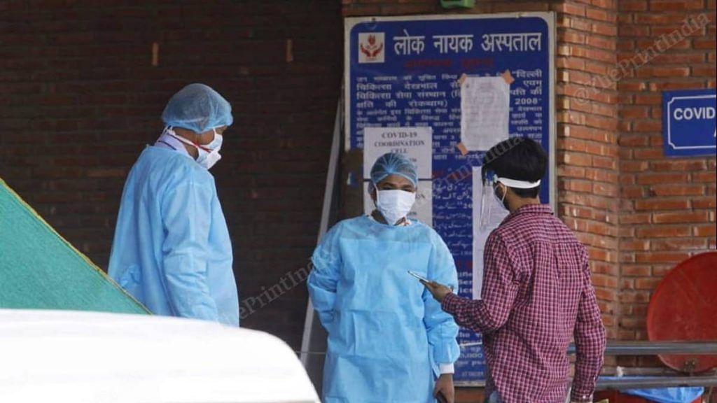 Healthcare workers screen people entering LNJP hospital in New Delhi | Praveen Jain | ThePrint