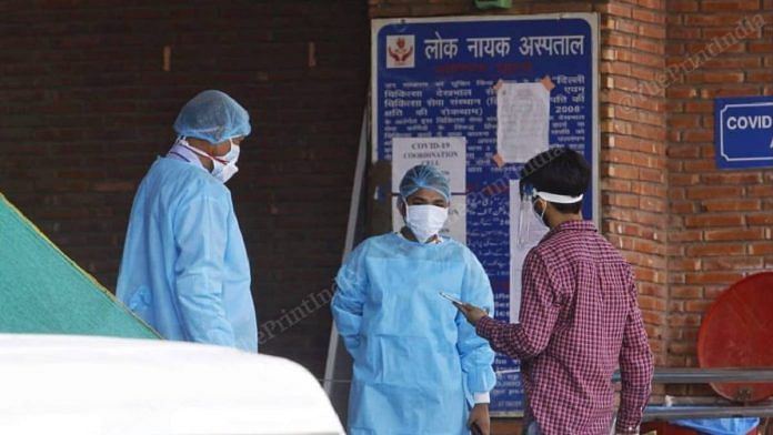 Healthcare workers screen people entering LNJP hospital in New Delhi | Praveen Jain | ThePrint