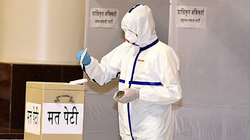Congress MLA Kunal Chaudhary, who had tested positive for Covid-19, cast his vote in Friday's Rajya Sabha elections in a full PPE kit | Photo: ANI