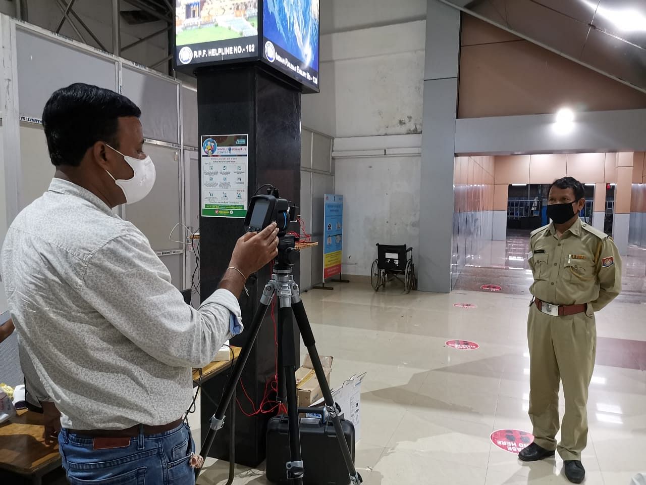 A surveillance worker screens a policeman at Guwahati railway station | Angana Chakrabarti | ThePrint